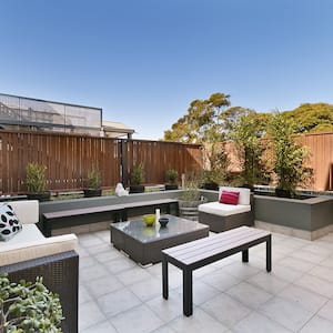 large patio space with wooden fence          